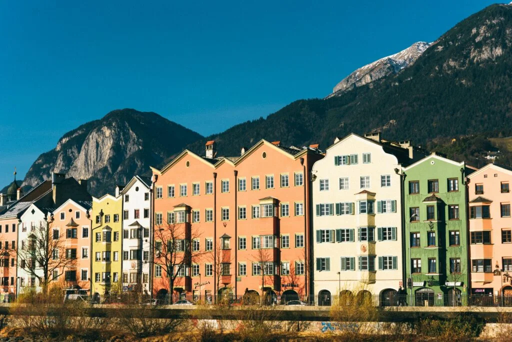 Colorful Buildings in Innsbruck in Austria in front of mountains